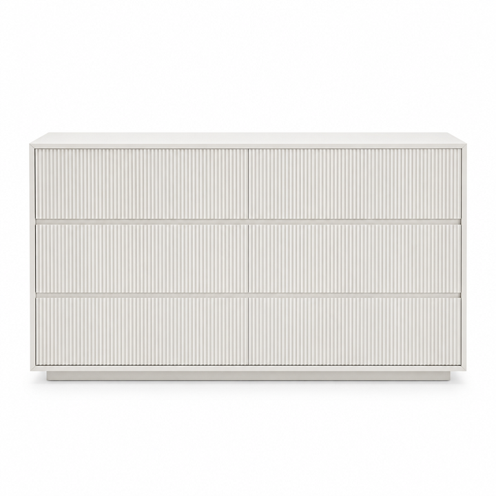 Front view of the Isola white fluted three-drawer dresser on white