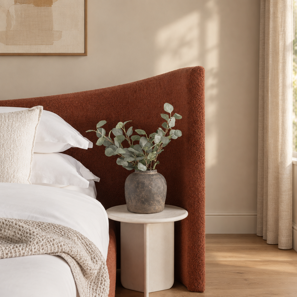 Wingback bed in a warm beige and wood interior