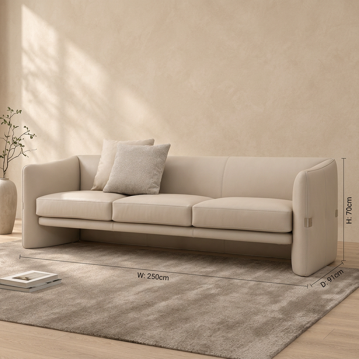 Neris beige curved-side leather sofa styled in a living room