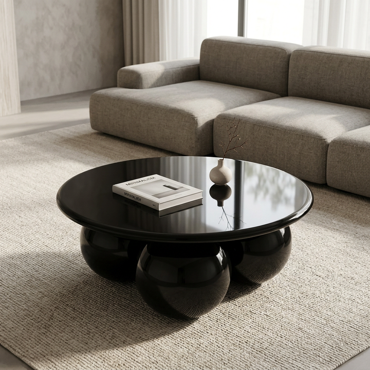 Vero black sphere-base coffee table styled in a contemporary living room